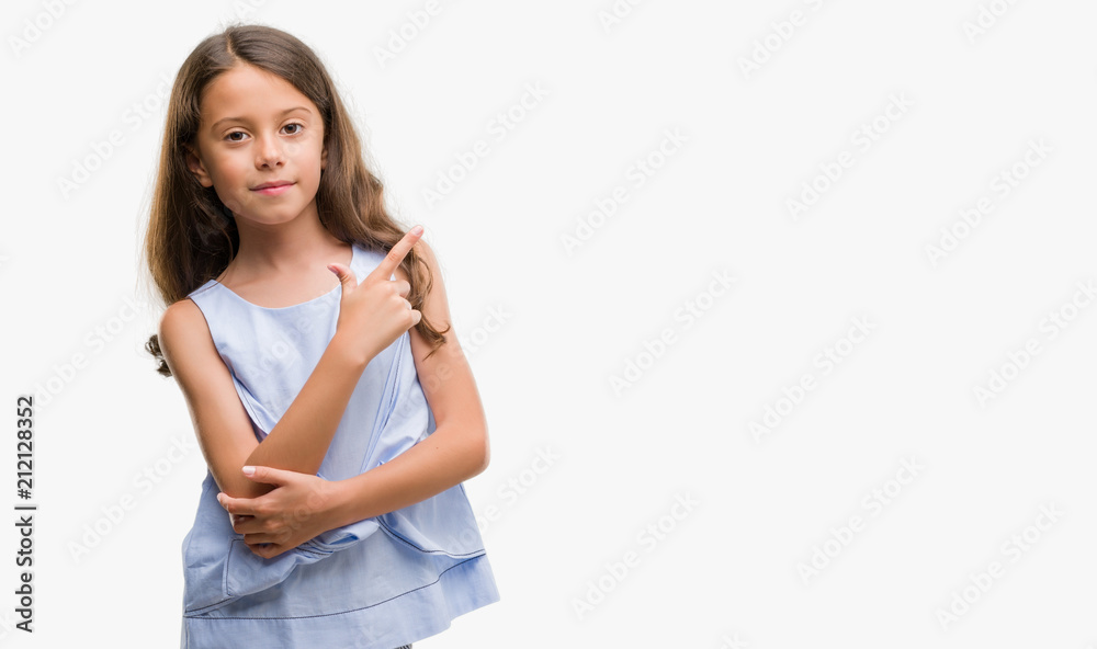 Brunette hispanic girl with a big smile on face, pointing with hand and finger to the side looking at the camera. Brunette hispanic girl with a big smile on face, pointing with hand and finger to the side looking at the camera.