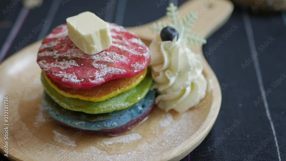 Fresh baked Rainbow Pancake with icing sugar berrie and butter Fresh baked Rainbow Pancake with icing sugar berrie and butter