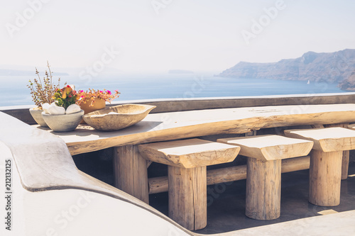 Beautiful vintage wooden table and chairs on terrace, Santorini © Martin M303