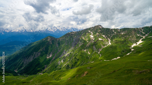 Fototapeta Naklejka Na Ścianę i Meble -  Green mountains on a background of snowy peaks in Mestia