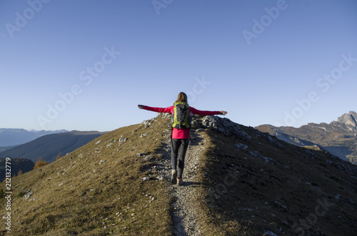 Girl tasting freedom in high mountain with open arms