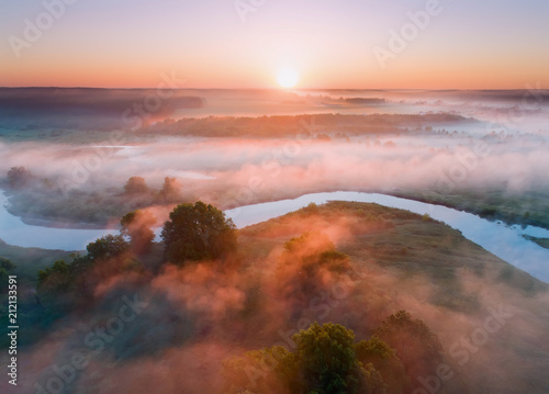 Summer aerial landscape. Sunrise over fog and river.