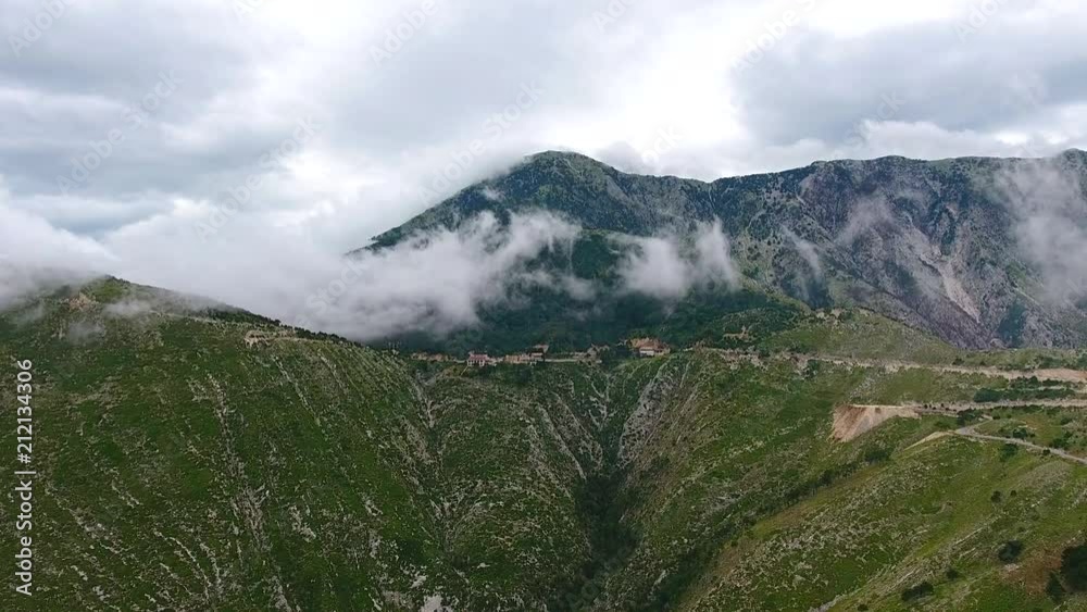 Aerial. Mountains in clouds at Llogara Pass, Llogara National Park, Albania. Footage near sea cost and high rocks in Albania summer. Aerial. Mountains in clouds at Llogara Pass, Llogara National Park, Albania. Footage near sea cost and high rocks in Albania summer.