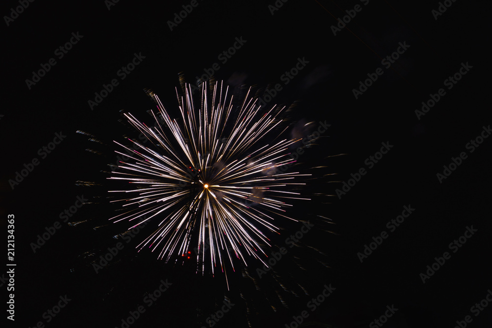 A beautiful bright colorful salute in the night sky of a big city due to a holiday A beautiful bright colorful salute in the night sky of a big city due to a holiday