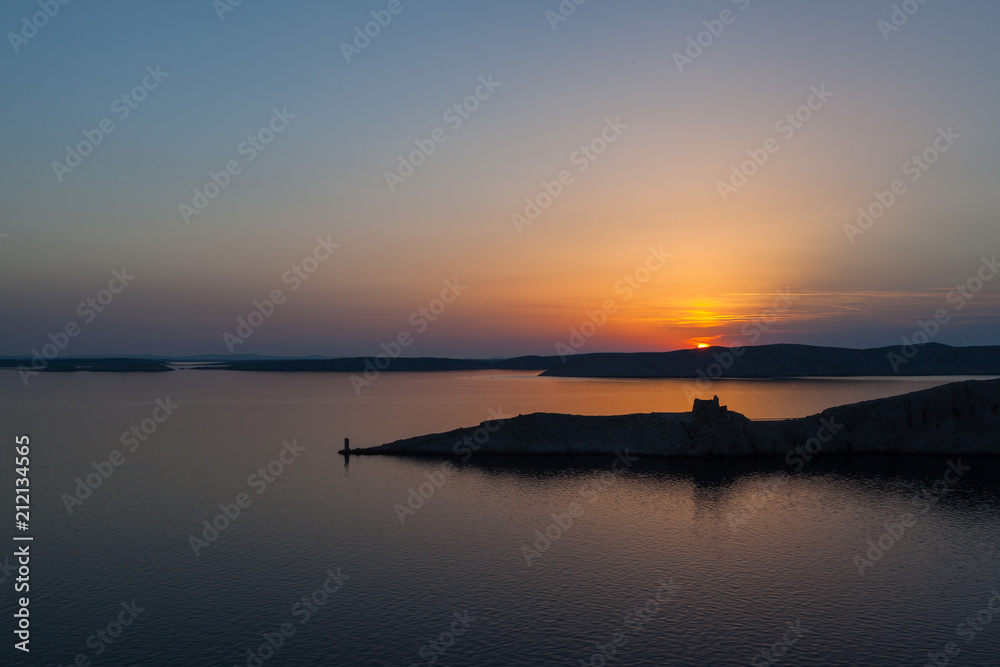 Sunset over turn of a fortress on the Croatian coast