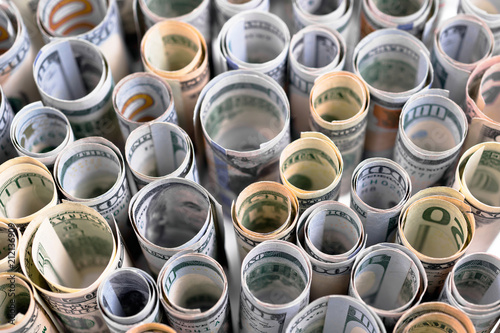 US dollars are exhibited in rows rolled up in tubules