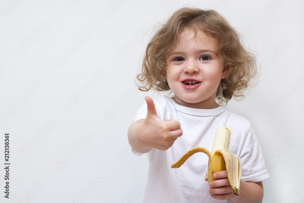 little girl holding yellow banana and show thumb up little girl holding yellow banana and show thumb up