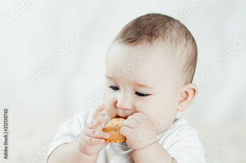 adorable baby eating a cookie photo