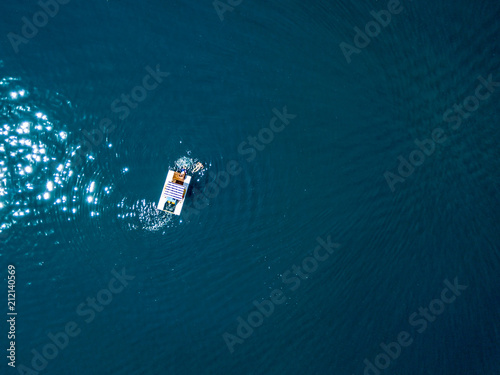 aerial top down view of small catamaran isolated on the water surface