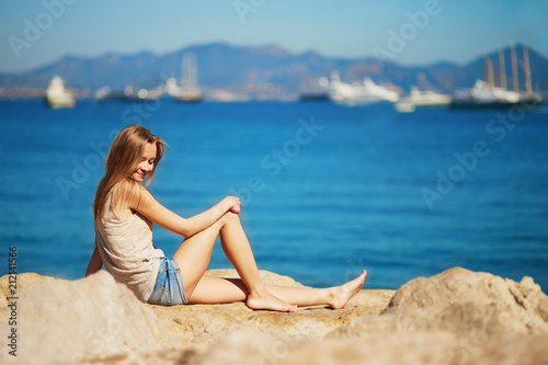 Young woman enjoying her vacation by the sea