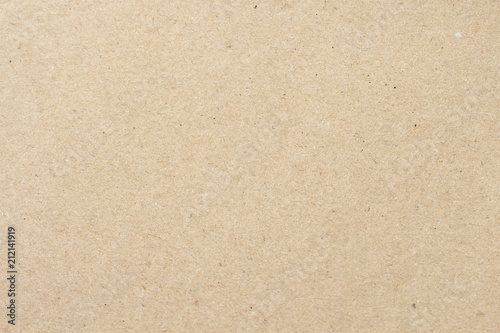 Cardboard, beige paper texture cardboard background close-up, surface with small inclusions of cellulose