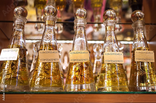 a row of colored bottles with perfume. Glass bottles with perfume. Perfumery, pleasant aromas. Love drink
