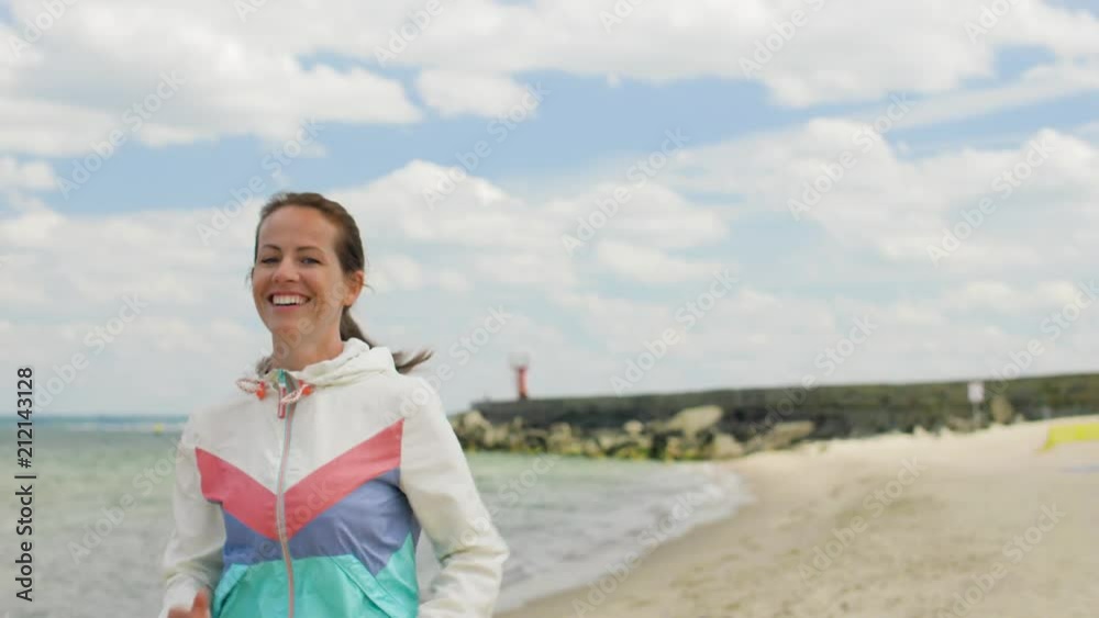 fitness, sport and healthy lifestyle concept - smiling woman running along beach fitness, sport and healthy lifestyle concept - smiling woman running along beach