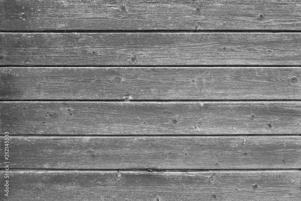 Full frame background of an old and faded wood board wall in black and white Full frame background of an old and faded wood board wall in black and white