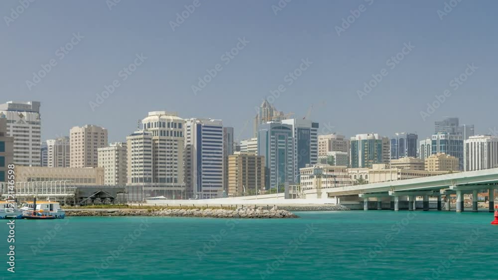 Modern buildings in Abu Dhabi skyline timelapse with mall and beach. Modern buildings in Abu Dhabi skyline timelapse with mall and beach.