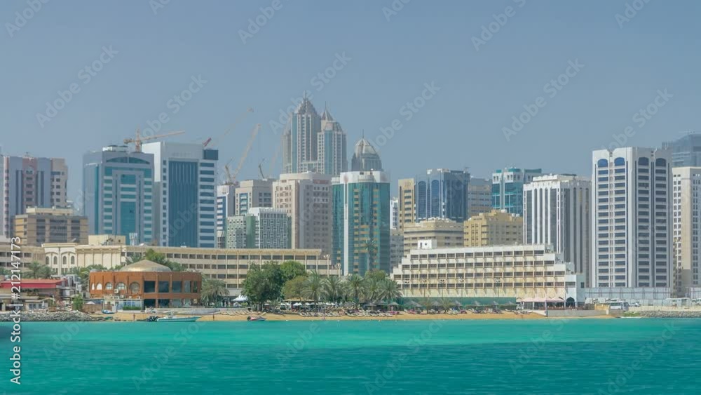 Modern buildings in Abu Dhabi skyline timelapse with mall and beach. Modern buildings in Abu Dhabi skyline timelapse with mall and beach.