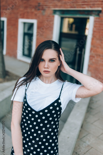 A beautiful girl in a long black sarafan walks down the street. loft style. © Денис Кипкаев