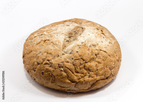 One round grain bread isolated on a white background.Whole fresh wheat and rye small bread with a lot of seeds: sunflower, pumpkin, sesame.