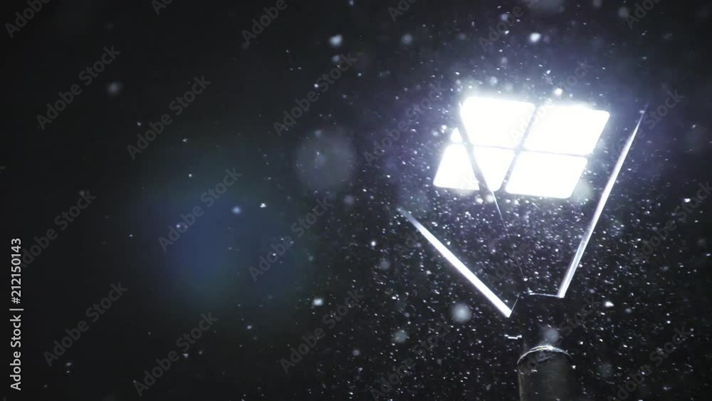 Snowing against the street lamp. Snow in slow motion in 180fps. Snowflakes beautifully fall. Snowing against the street lamp. Snow in slow motion in 180fps. Snowflakes beautifully fall.