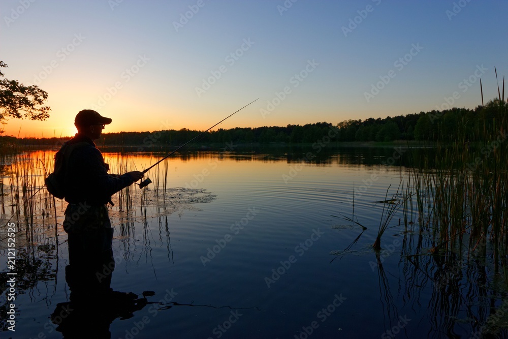 Fisherman catching the fish during sunset Fisherman catching the fish during sunset
