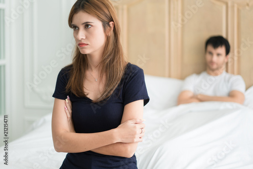 Unhappy couple not talking after an argument in bed at home. People, relationship difficulties and family concept.
