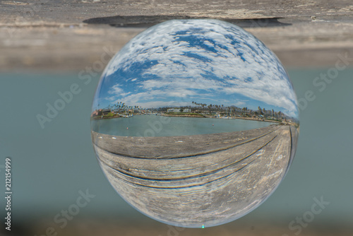 Fish eye distortion of cloudy blue sky over calm water of Ventura Marina cove.