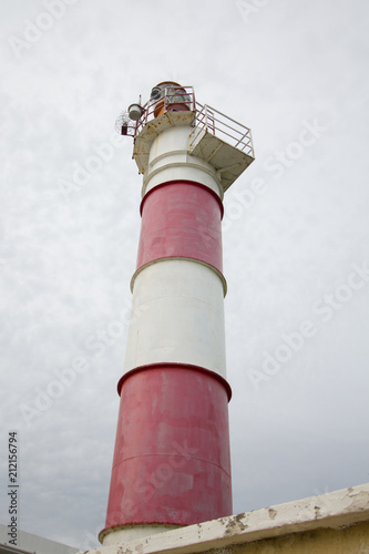 Lighthouse on a cloudy sky background