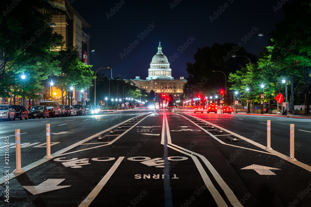 Fototapeta premium Bike lanes on Pennsylvania Avenue and the United States Capitol at night, in Washington, DC.