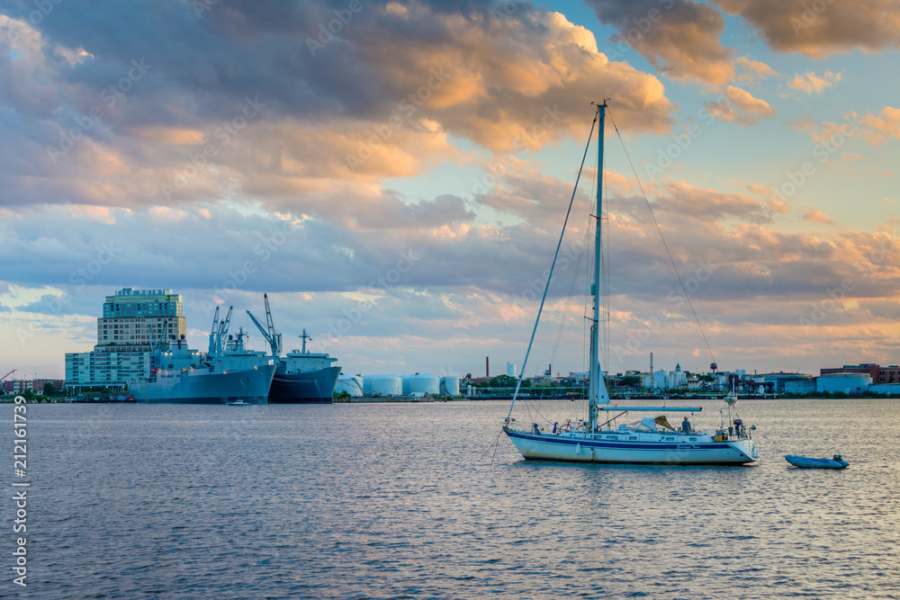 Sailboat in the harbor and view of Silo Point at sunset, in Canton, Baltimore, Maryland