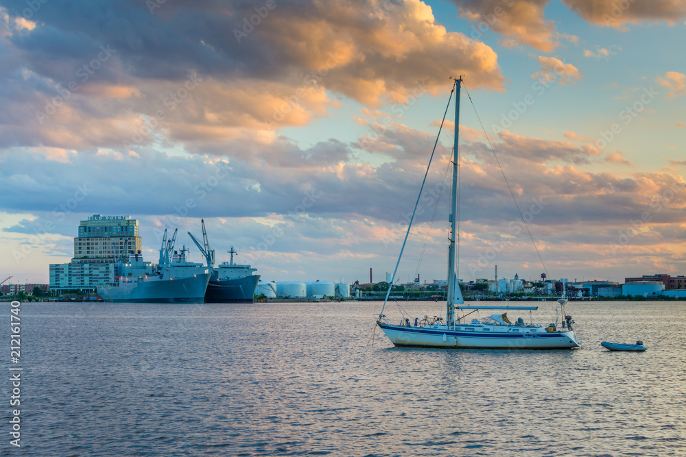 Sailboat in the harbor and view of Silo Point at sunset, in Canton, Baltimore, Maryland