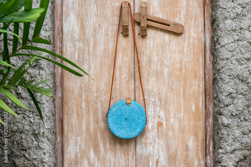 Fashionable stylish rattan bag in the tropical garden. photo