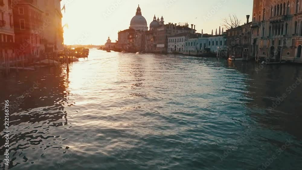 aerial flight down venice canal at sunrise in italy
