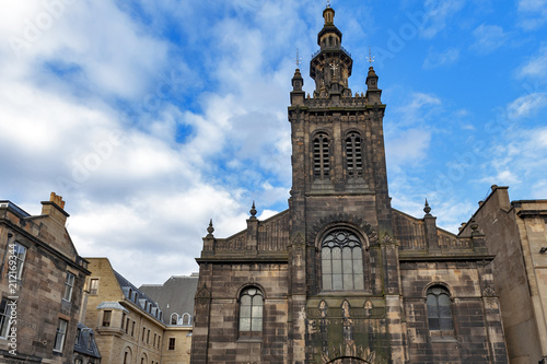 Front facade of Augustine Church Centre in Edinburgh, Scotland, showing a mixture of Romanesque, Renaissance and Classical architecture topped by a three-tiered tower
