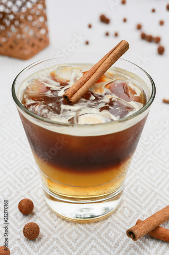 coffee cocktail on the table decorated with a stick of cinnamon