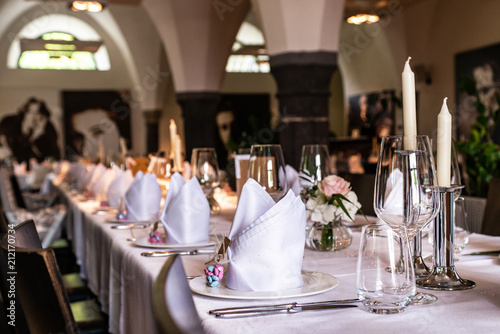 Table setup at marriage waiting for guests with dishes water flowers