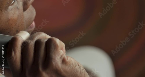 Elderly black woman dialing 911 on a cordless landline phone - OTS