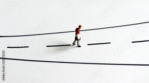 A miniature man walking alone on the street. © Hyejin Kang