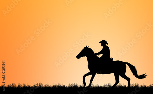 silhouette Cowboy riding a horse on sunrise