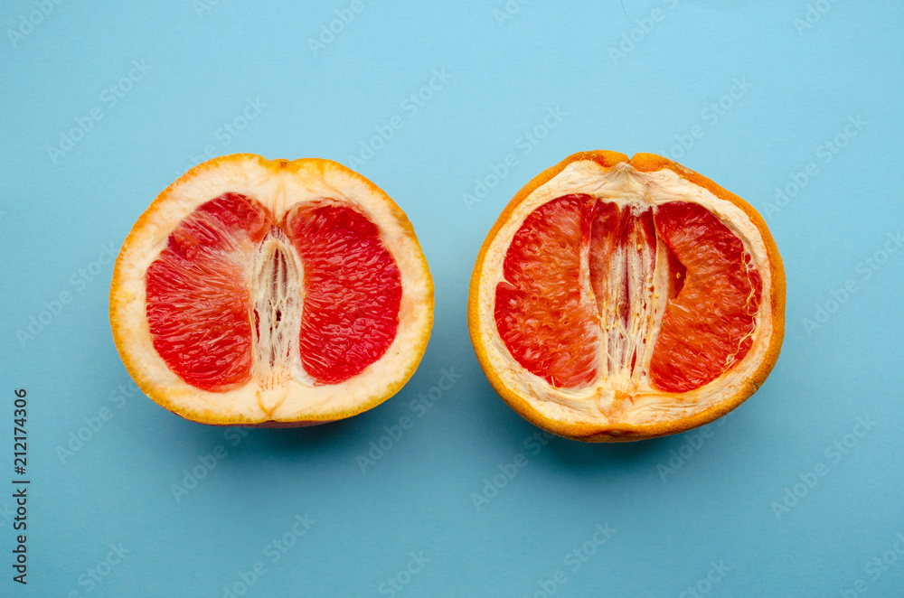 Fresh grapefruit and stale grapefruit on a blue background. Concept of