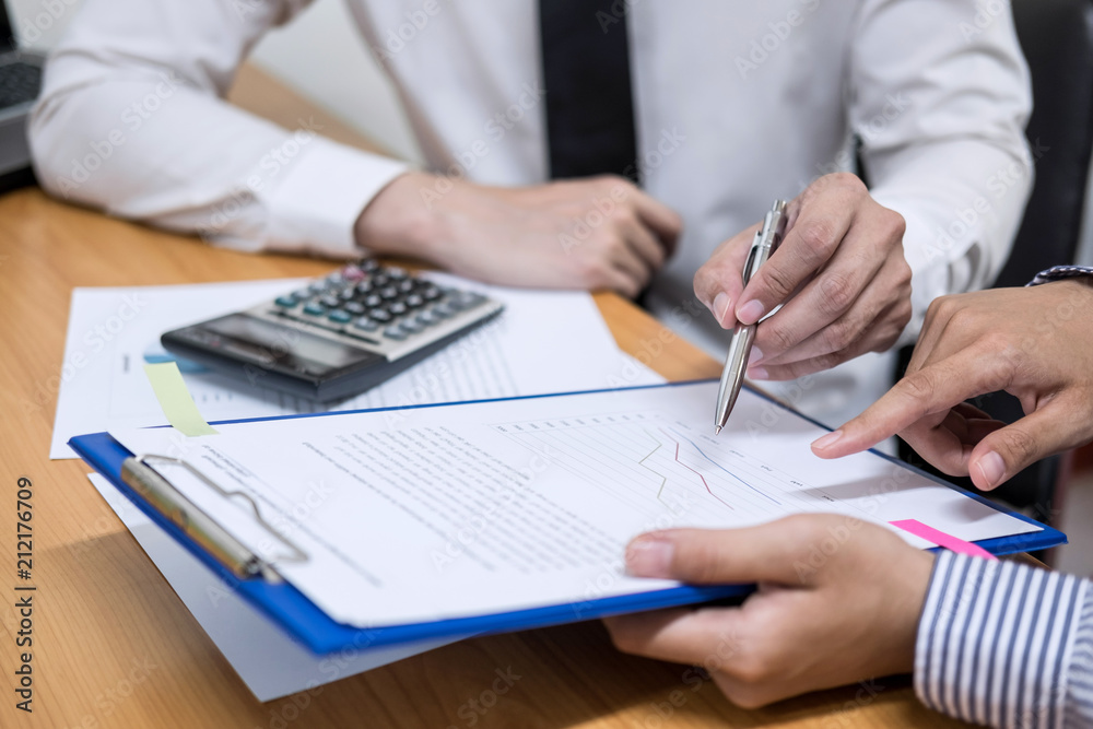 Two business team working and discussing Financial investment on report with calculate Analyze business and market growth on financial document data graph Two business team working and discussing Financial investment on report with calculate Analyze business and market growth on financial document data graph