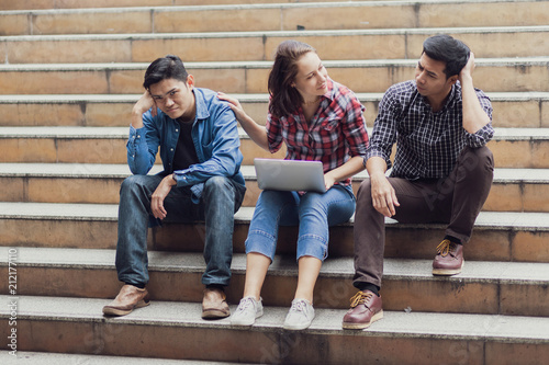 group of people thinking about work with laptop and sit outdoor on steps