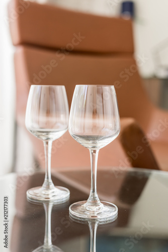 Two glasses on the table. Vertical. Hotel.