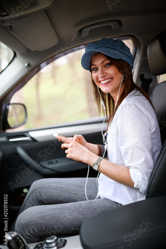 Woman in car holding cell phone © luckybusiness