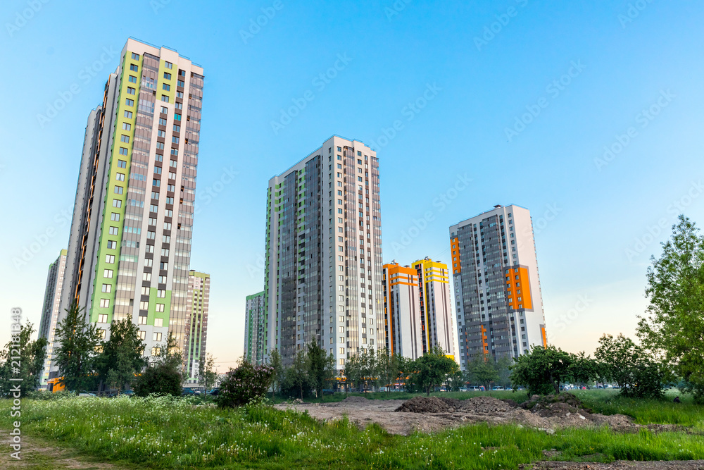 Cityscape on the clear blue sky: bright color high-rise buildings for living