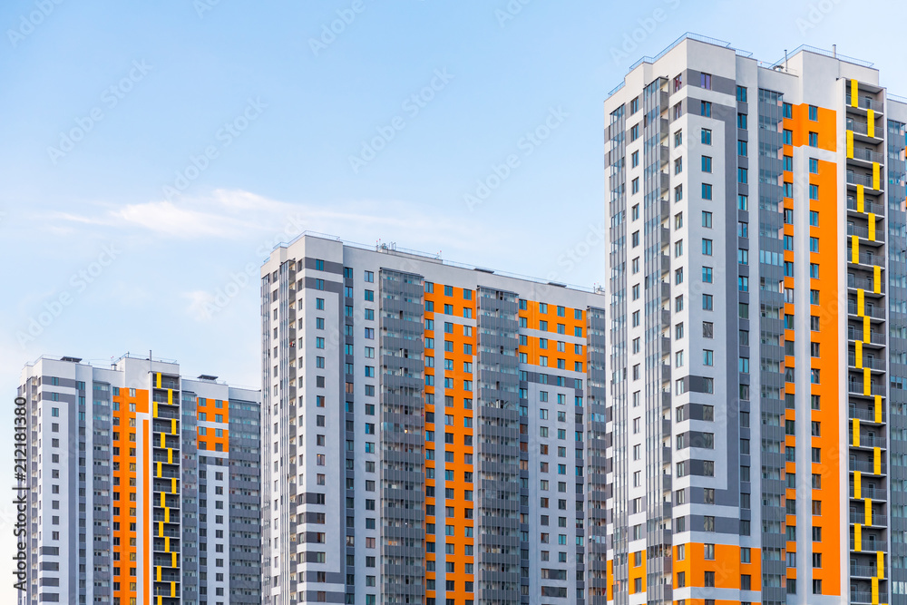 Cityscape on the clear blue sky: bright color high-rise buildings for living