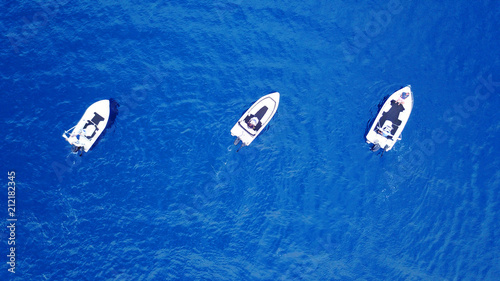 Aerial birds eye view from drone of boats cruising in deep blue sea © aerial-drone