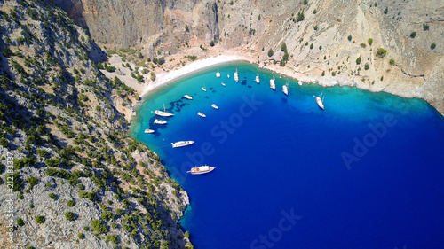 Aerial birds eye view photo taken by drone of famous tropical rocky beach of Agios Georgios with yachts docked, Symi island, Dodecanese, Greece photo