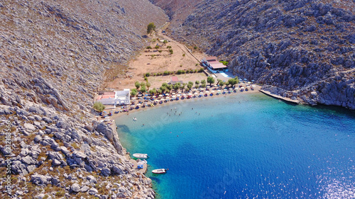 Aerial bird's eye view photo taken by drone of famous tropical rocky beach of Agios Nikolaos with clear turquoise waters, Symi island, Dodecanese, Greece photo