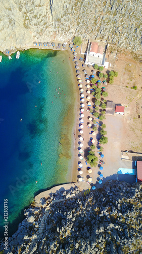 Aerial bird's eye view photo taken by drone of famous tropical rocky beach of Agios Nikolaos with clear turquoise waters, Symi island, Dodecanese, Greece © aerial-drone