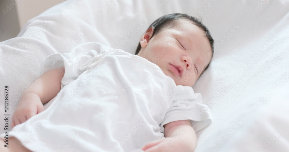 New born baby sleep on bed